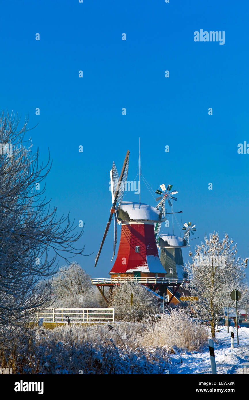 twin windmills in winter scenery, Germany, Lower Saxony, East Frisia