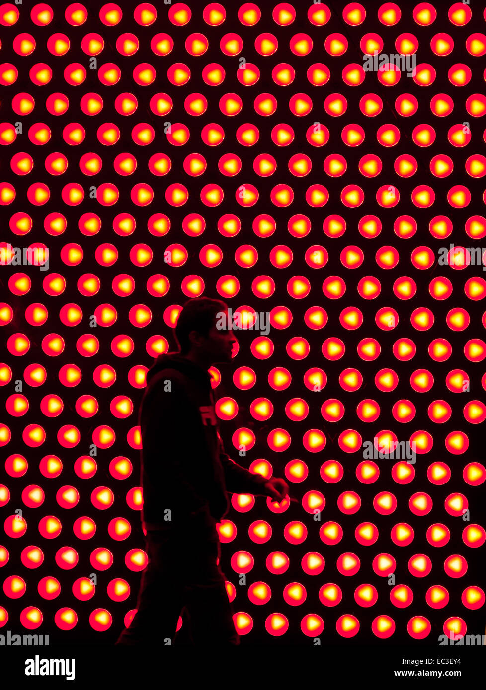 Silhouette of a man in front of the lights of the Esprit fashion ... Silhouette of a man in front of the lights of the Esprit fashion ...