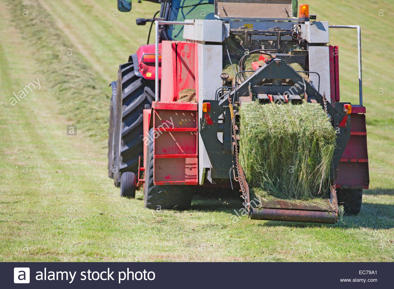 Tractor baling hay in field Stock Photo, Royalty Free Image 76378345
