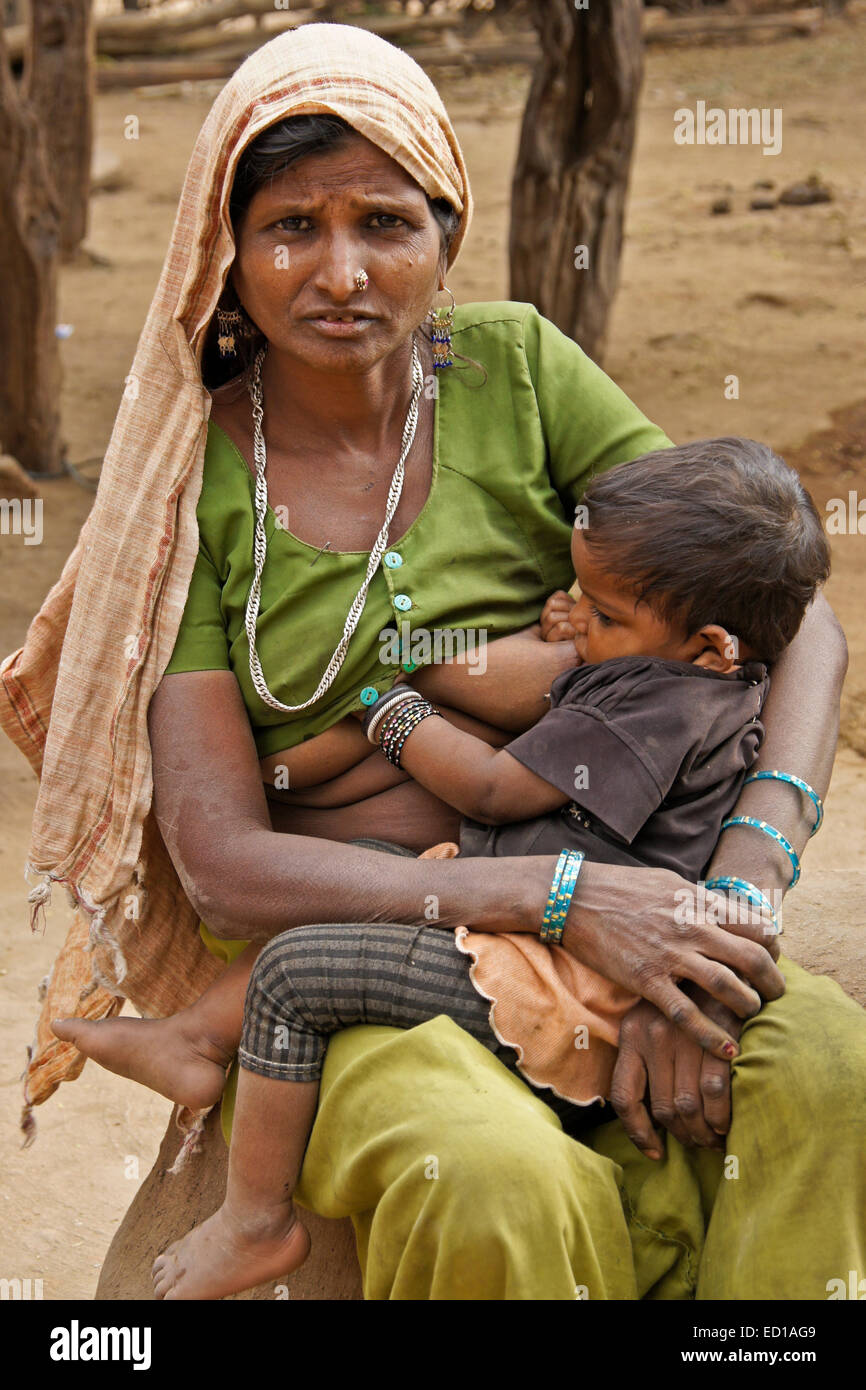 Woman of Adivasi tribe nursing her child in village near Poshin pic