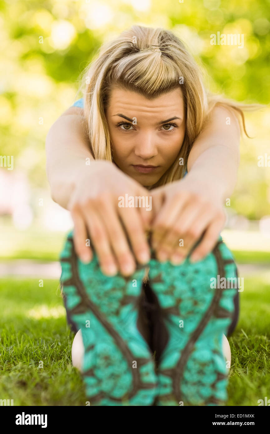 Fit Blonde Stretching On The Grass Stock Photo Alamy