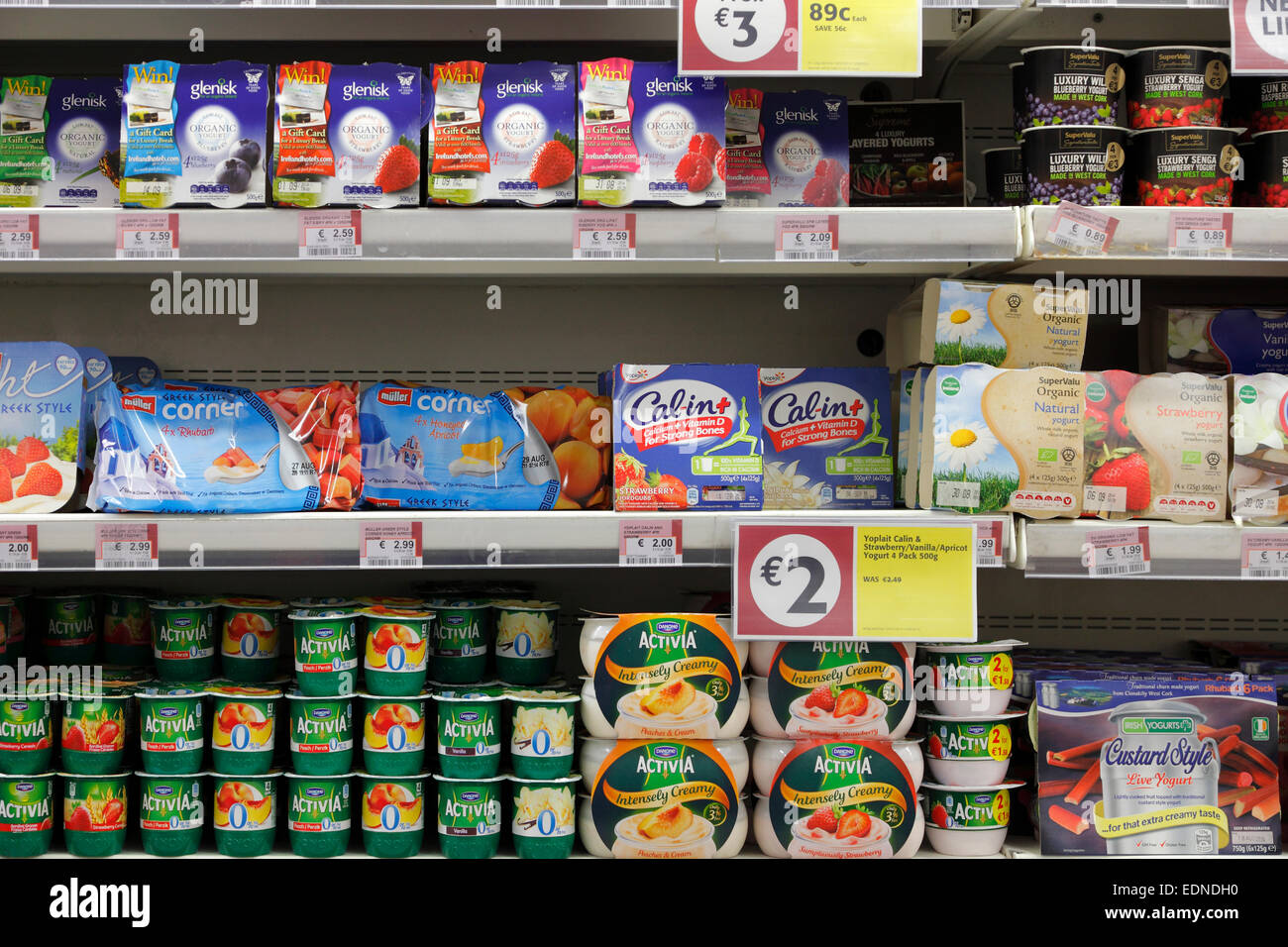 Yogurt Cups In A Refrigerated Shelf In A Supermarket Stock Photo