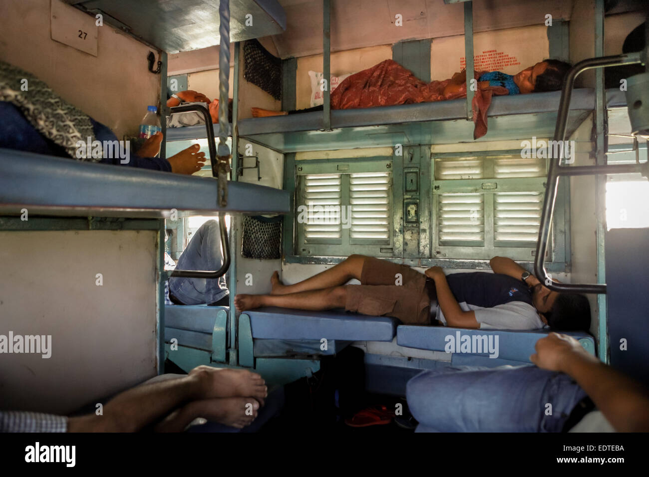 Passengers sleeping in sleeper class of the India railway service Stock