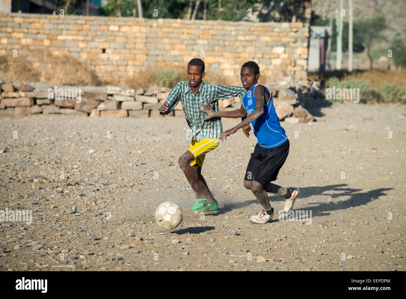 Children play football on a dirt pitch in Abala, Ethiopia, Africa Stock