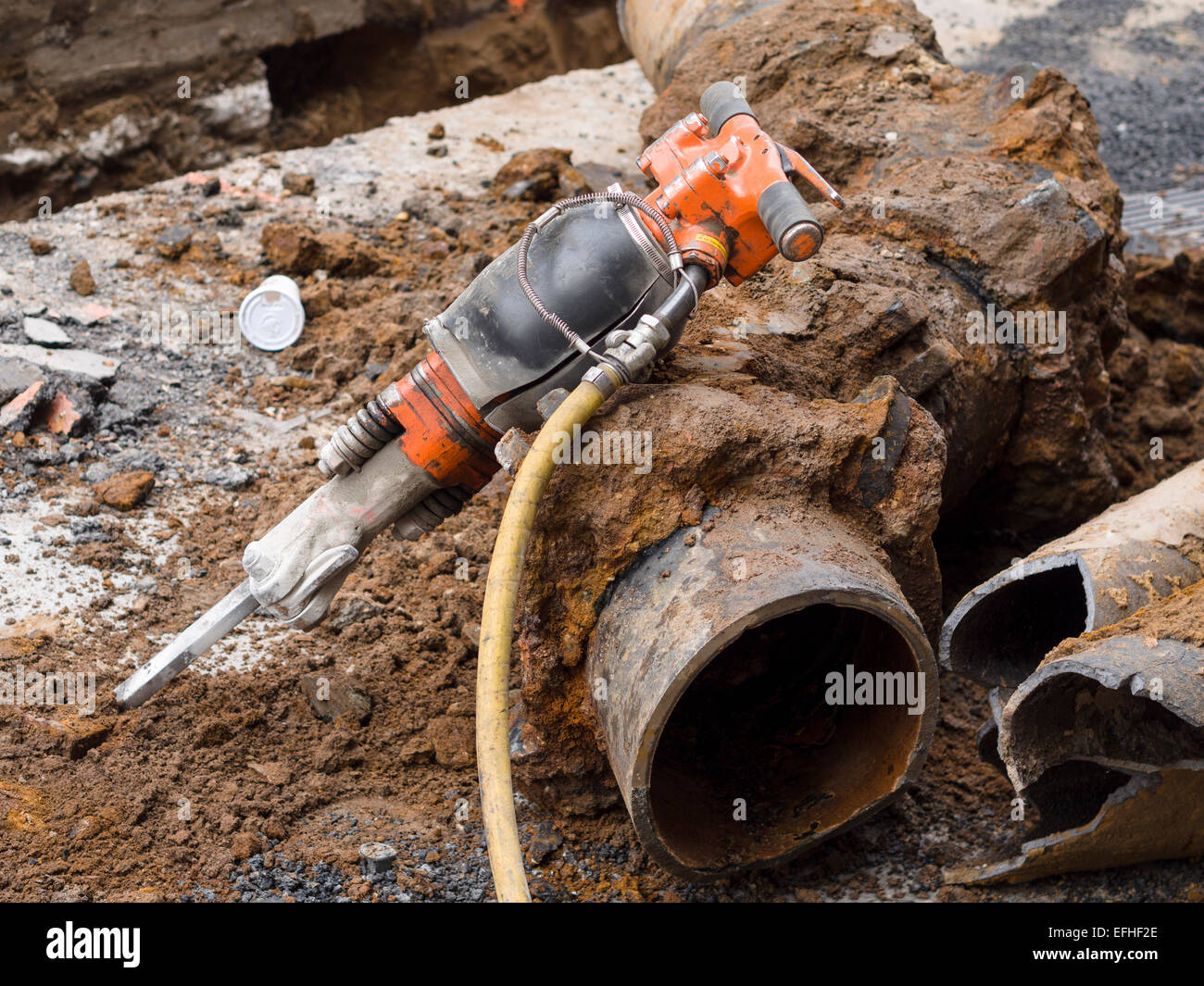 a-large-jackhammer-waits-for-its-operator-the-orange-tool-leans-on-EFHF2E.jpg