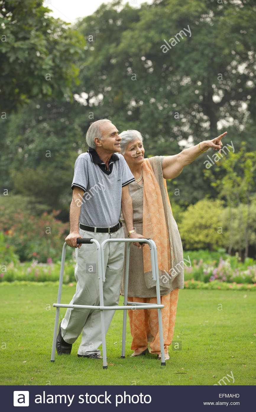 indian-old-couple-walking-in-a-lawn-EFMA