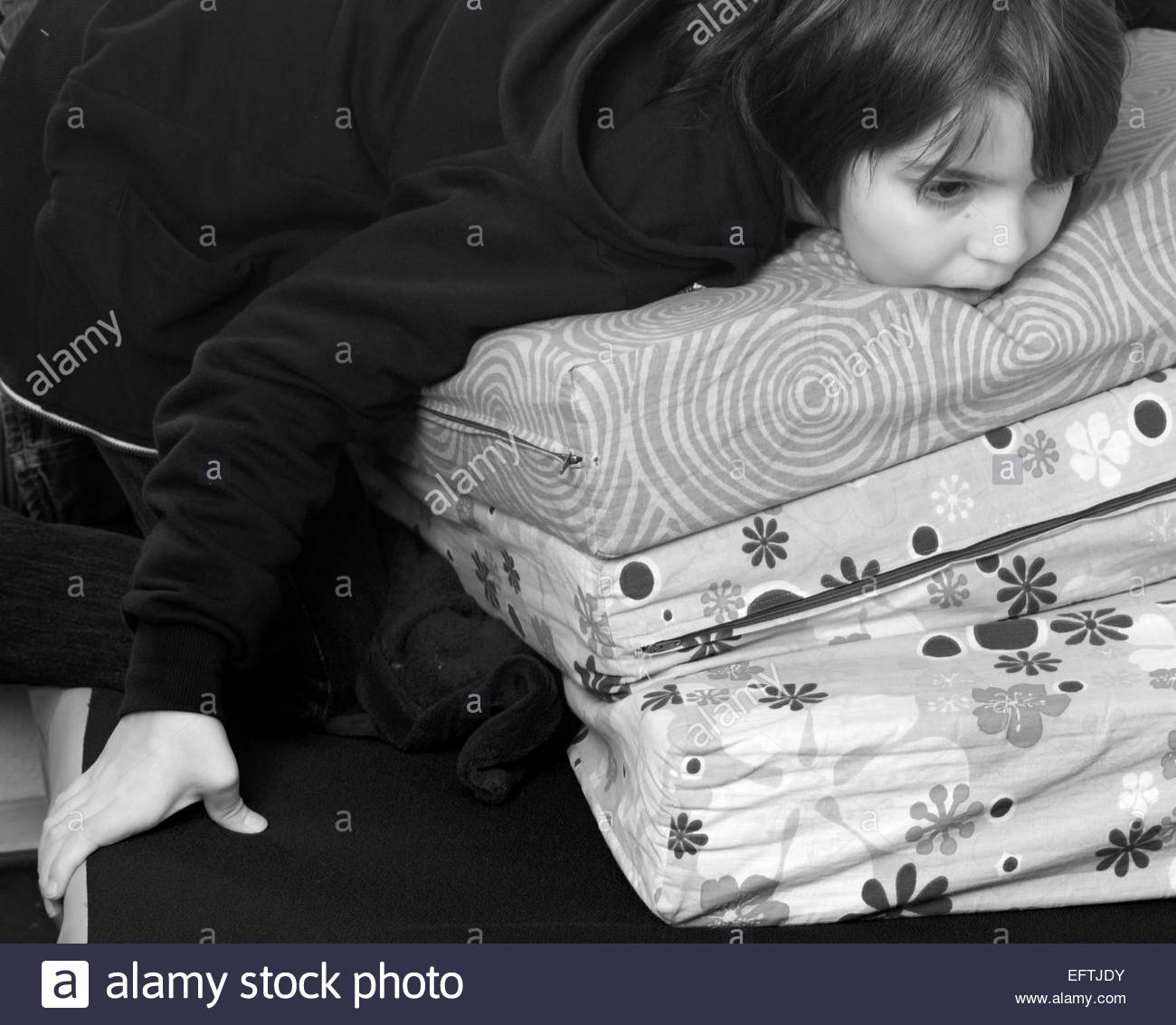 black kids watching tv. child kid boy children kids watching tv television lying on bed funny hands serious thinking male age 9 years alone caucasian black tv
