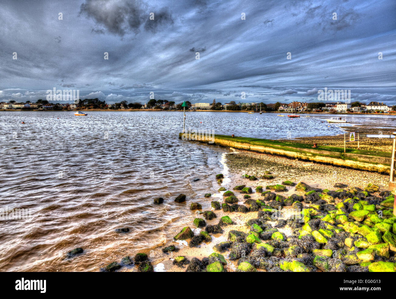 Christchurch harbour near Mudeford Dorset England UK with rocks green