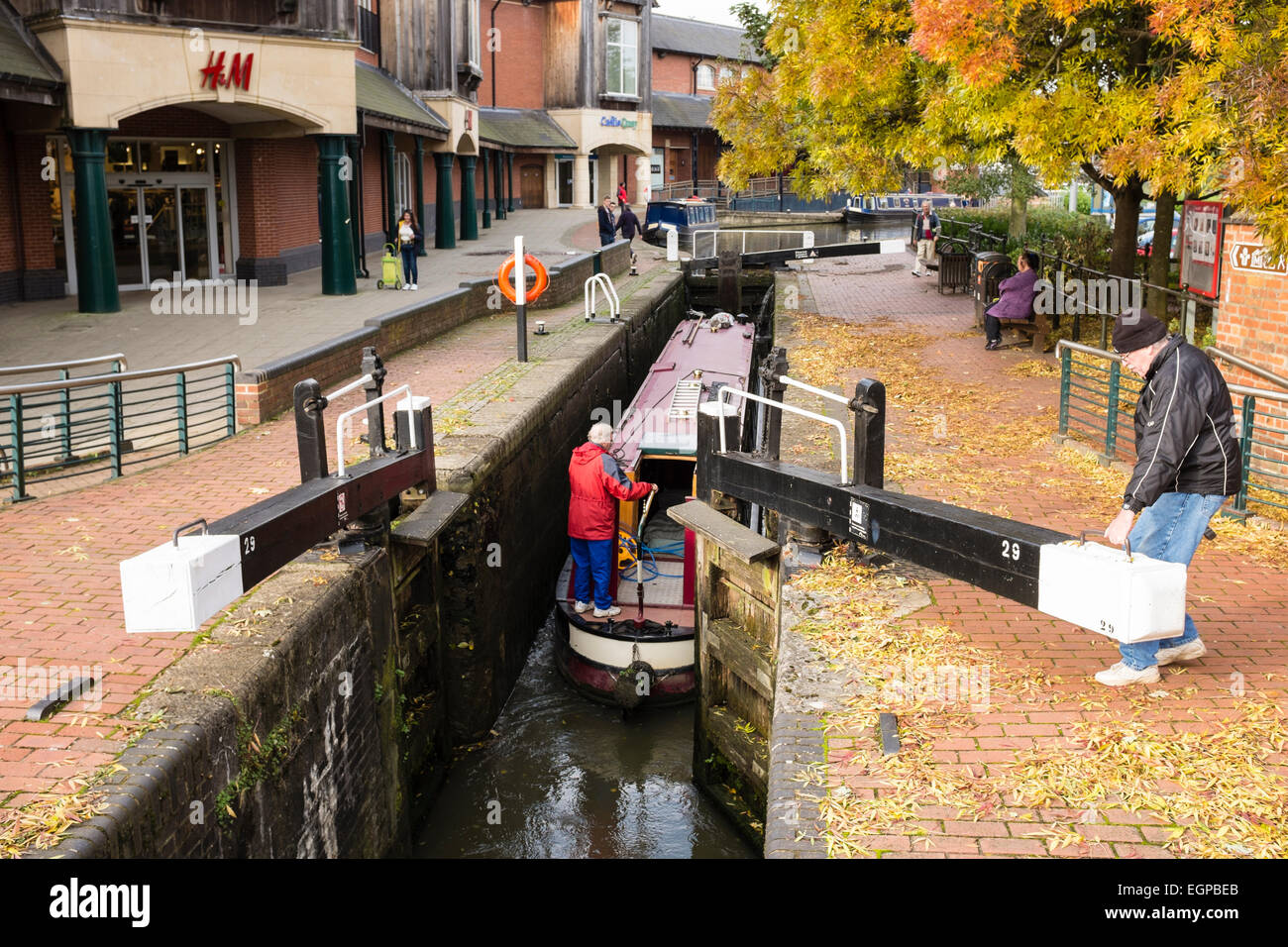 A barge negotiates the Oxford Canal lock gates in the centre of the