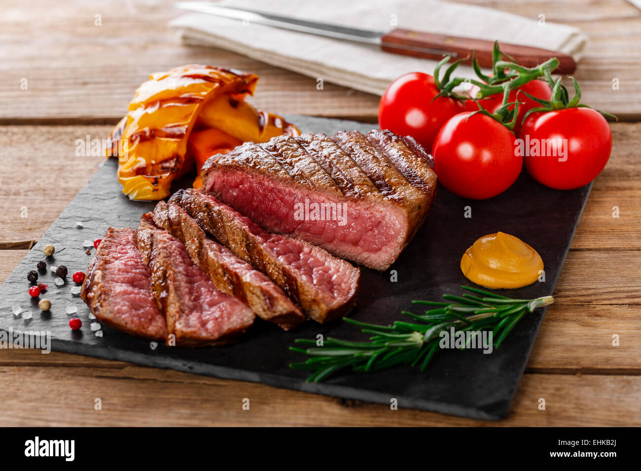 grilled beef steak rare sliced with vegetables stock photo