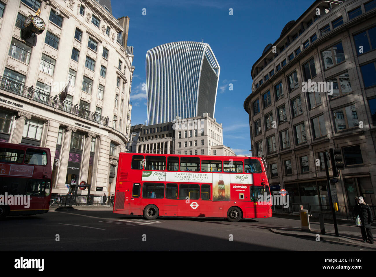 London bus passes Monument tube station in the City of London with