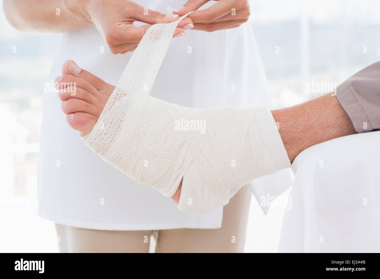 Doctor Bandaging Her Patient Leg Stock Photo Alamy