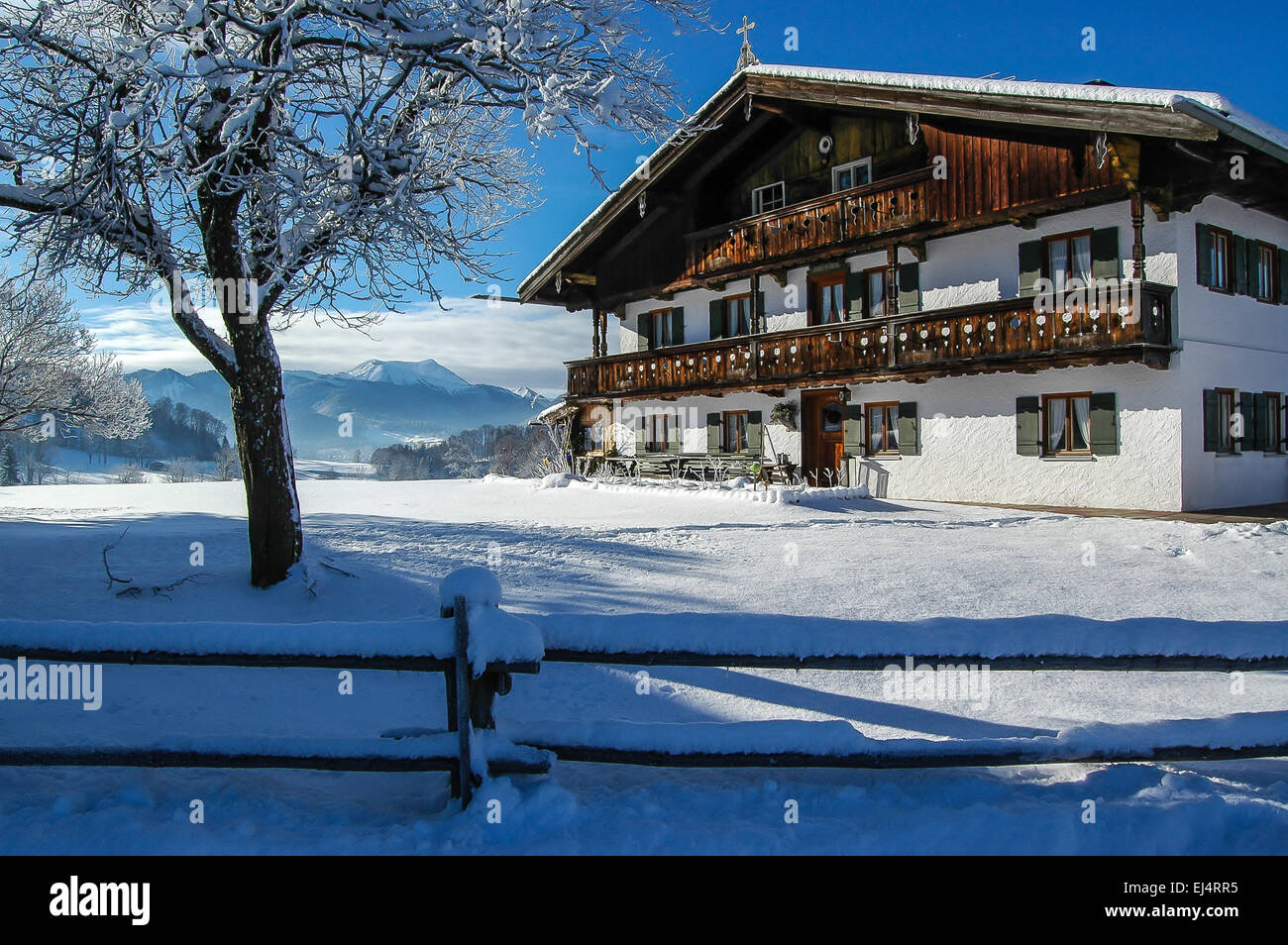 Winter in the Bavarian Alps farm house blue winter sky Stock Photo