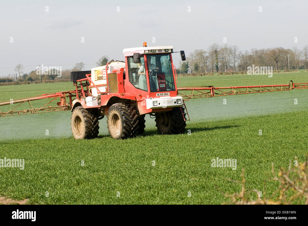 tractor spraying crops crop spraying tractors field fields farm Stock
