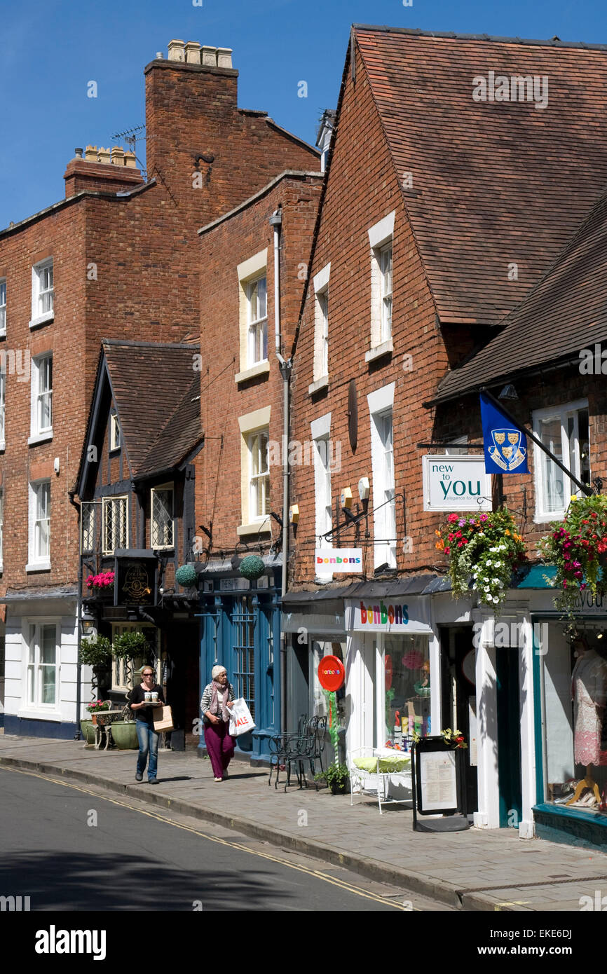 Shrewsbury town centre. Two shoppers walk past attractive shops on a