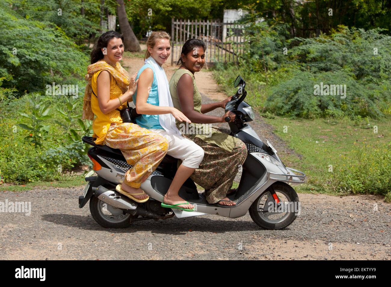 Three Girls Riding A Motorized Scooter Sathyamangalam Tamil Nadu India Three Girls Riding A Motorized Scooter Sathyamangalam Tamil Nadu India