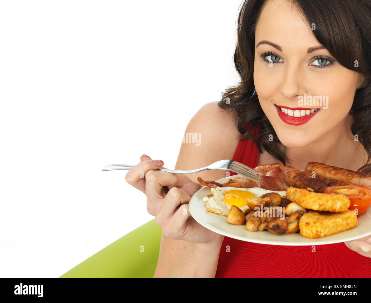 Stock Photo - Young Attractive Woman Eating a <b>Full English</b> Breakfast - young-attractive-woman-eating-a-full-english-breakfast-EMH85N