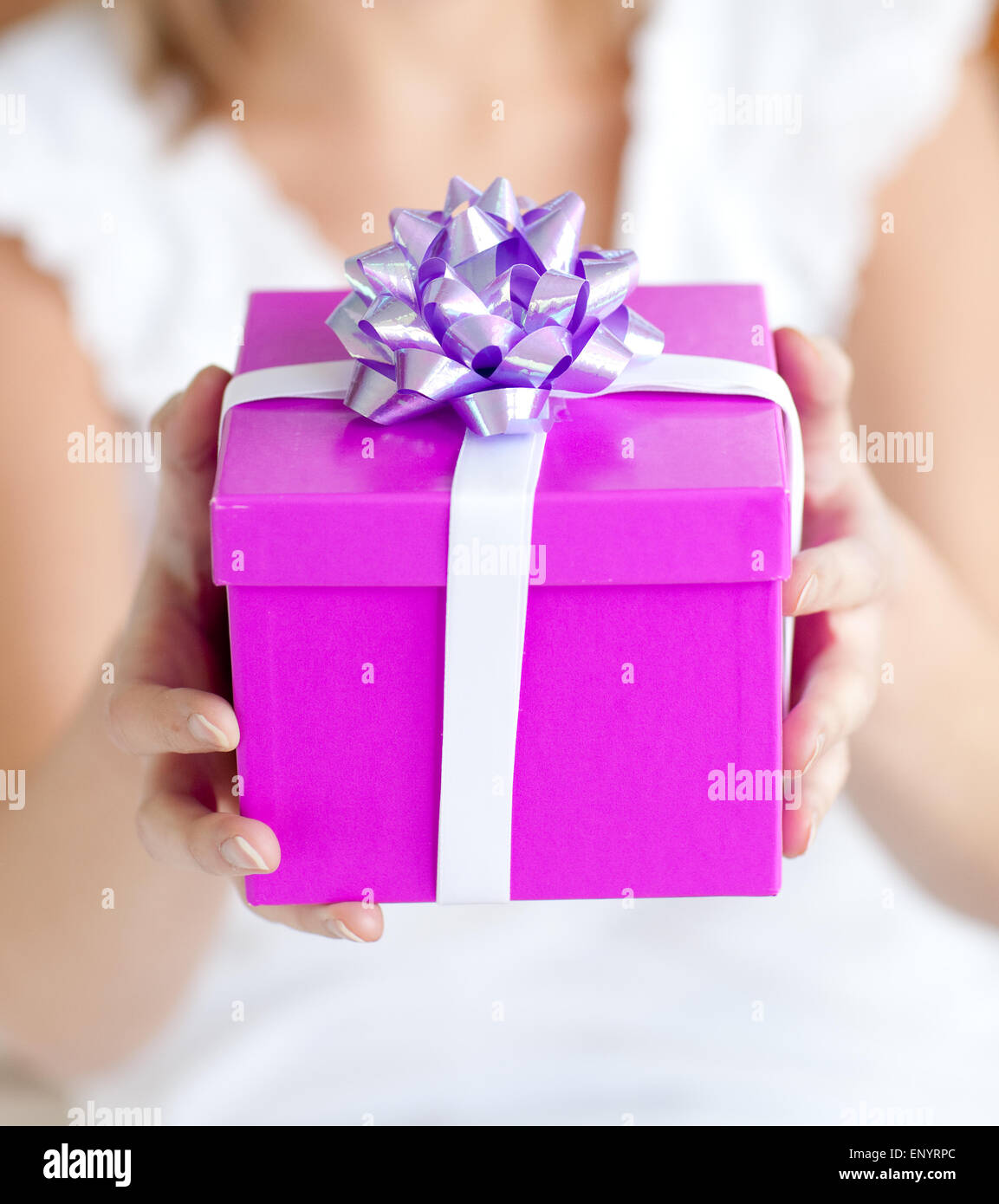 Close Up Of A Woman Holding A Present Sitting On The Floor Stock Photo