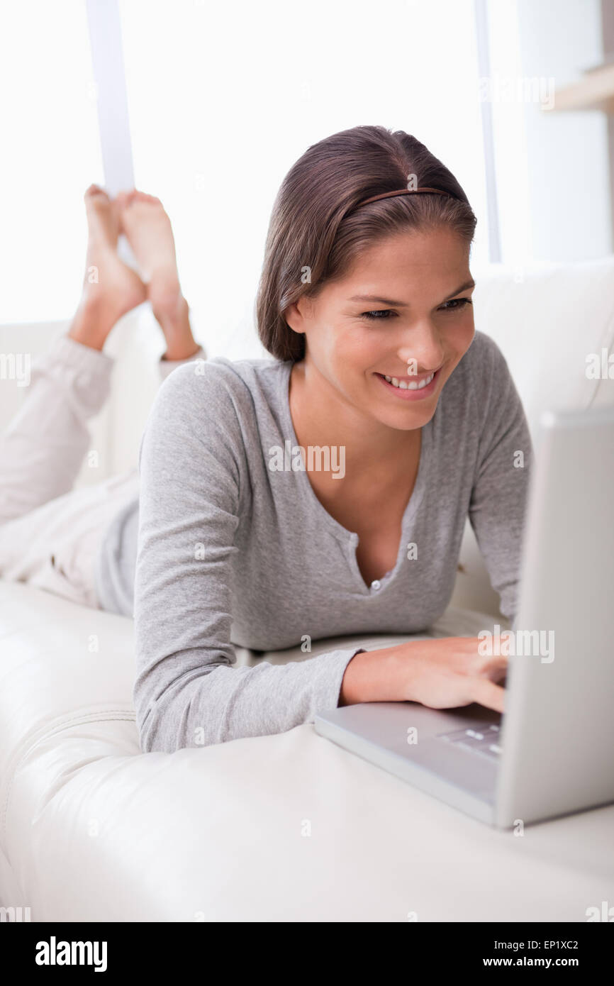 Smiling Lying On The Sofa With Laptop Stock Smiling Lying On The Sofa With Laptop Stock