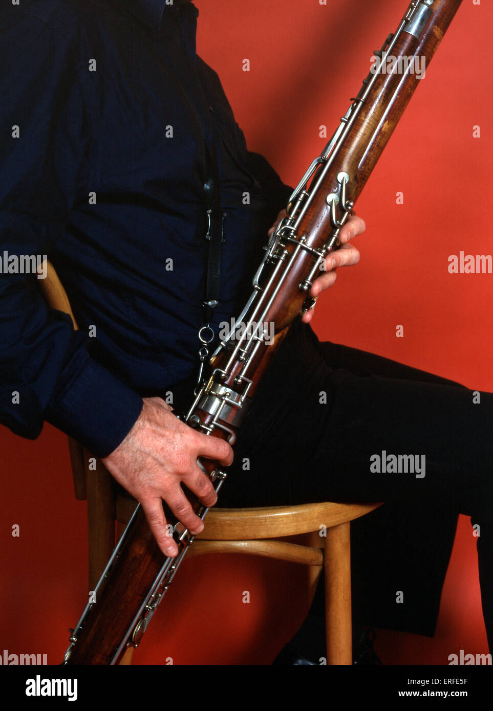 Bassoonist playing bassoon close up of hands on keys. Illustrates