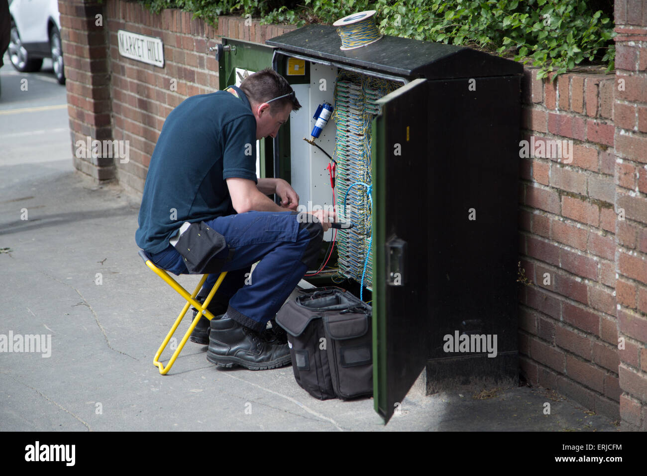 BT engineer on a junction box on the roadside England UK Stock Photo