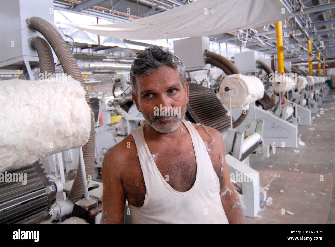 Mill workers working in textile mill ; Bombay now Mumbai Stock Photo