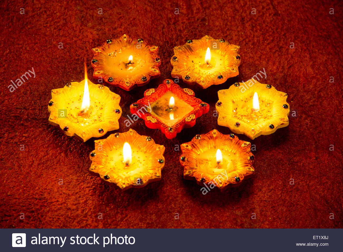 Decorative And Traditional Illuminated Diwali Lamps On Red