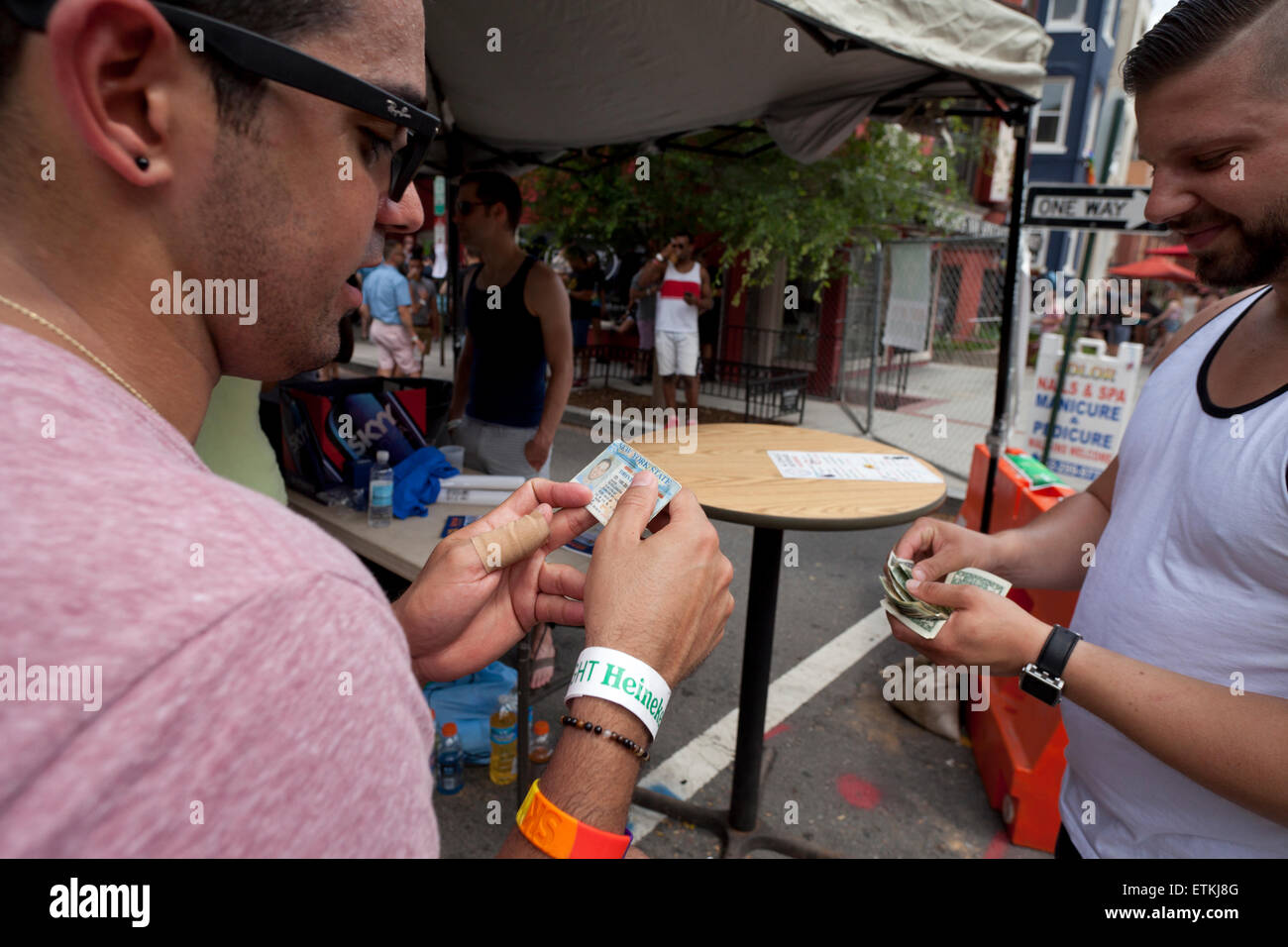 Bouncer checking ID at bar entrance USA Stock Photo, Royalty Free