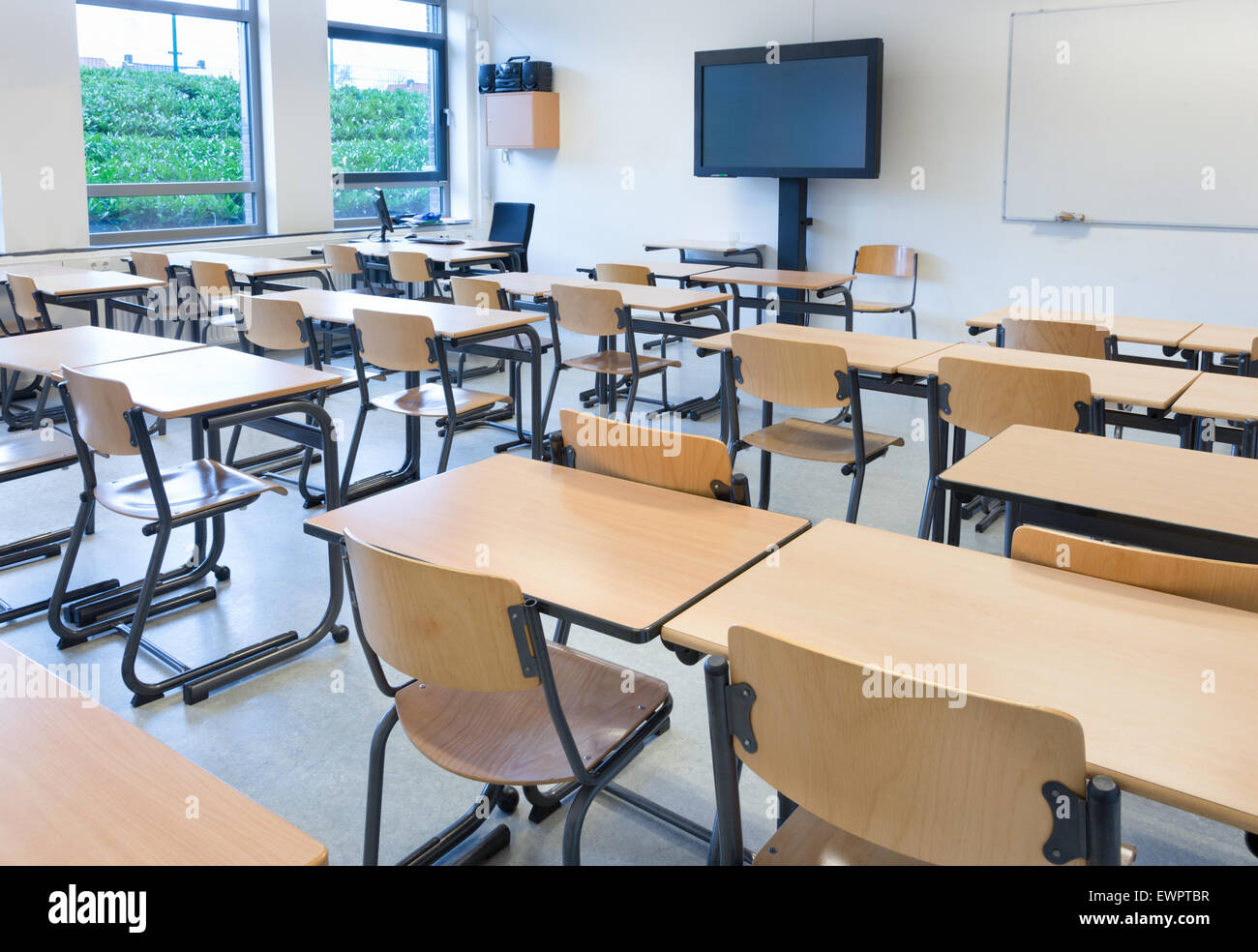 Empty Classroom With Tables And Chairs In School Building Stock