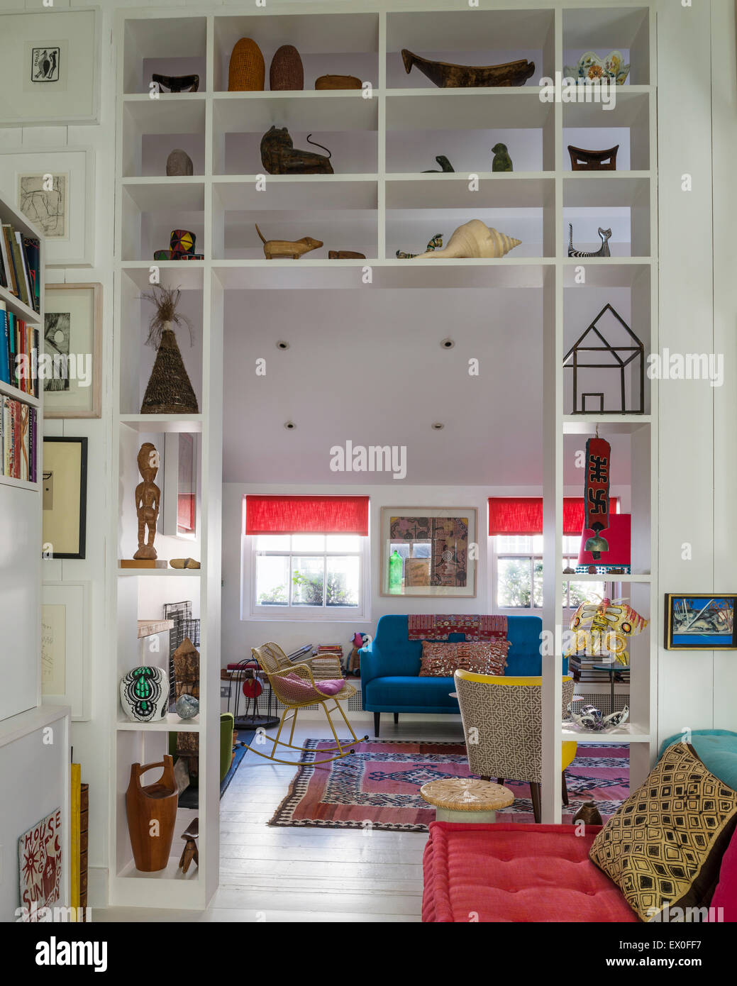 Small Sculptures And Artefacts On Open Shelving In Living Room
