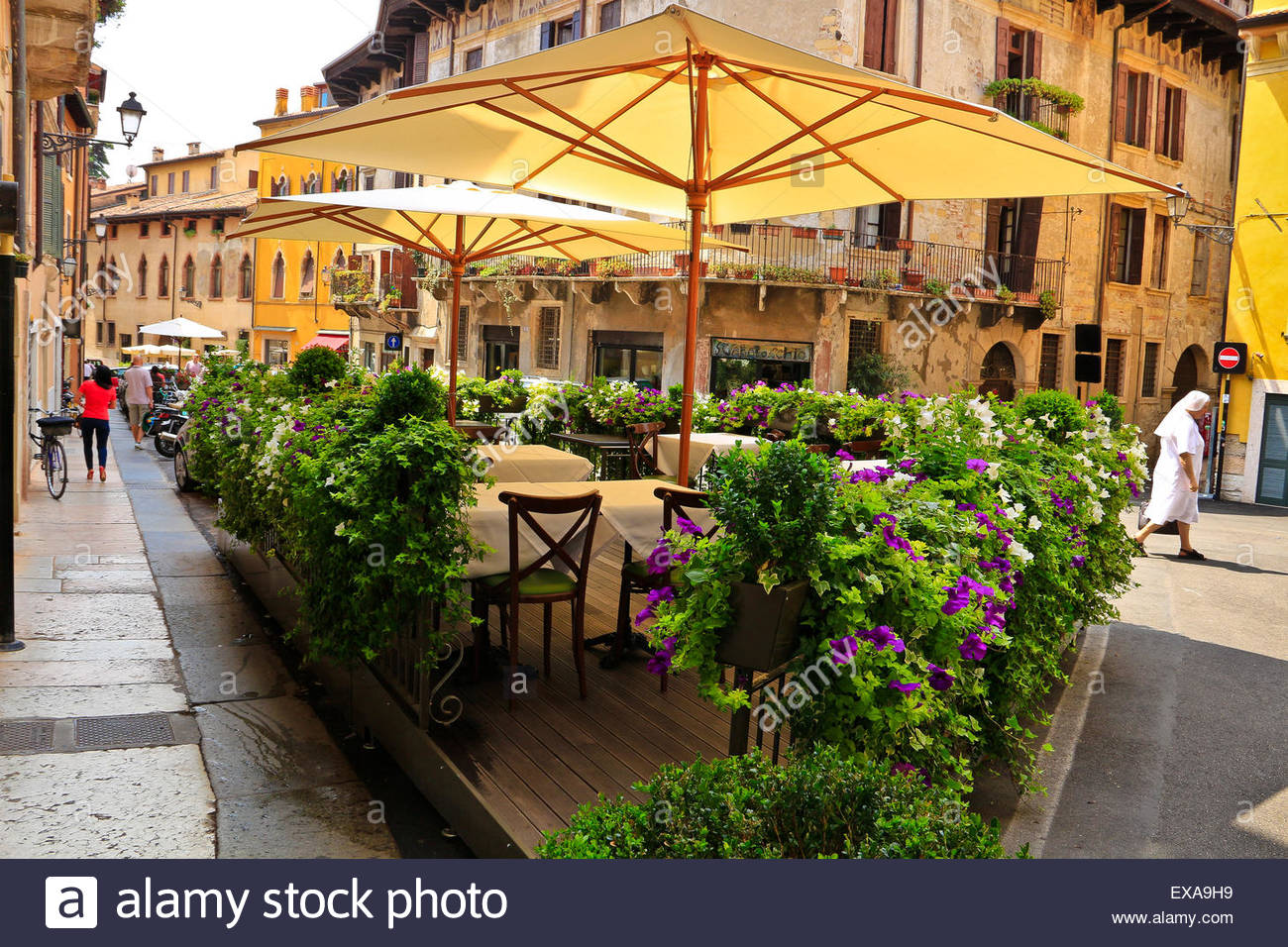 Outdoor seating, restaurant, sun shades and potted plants ...