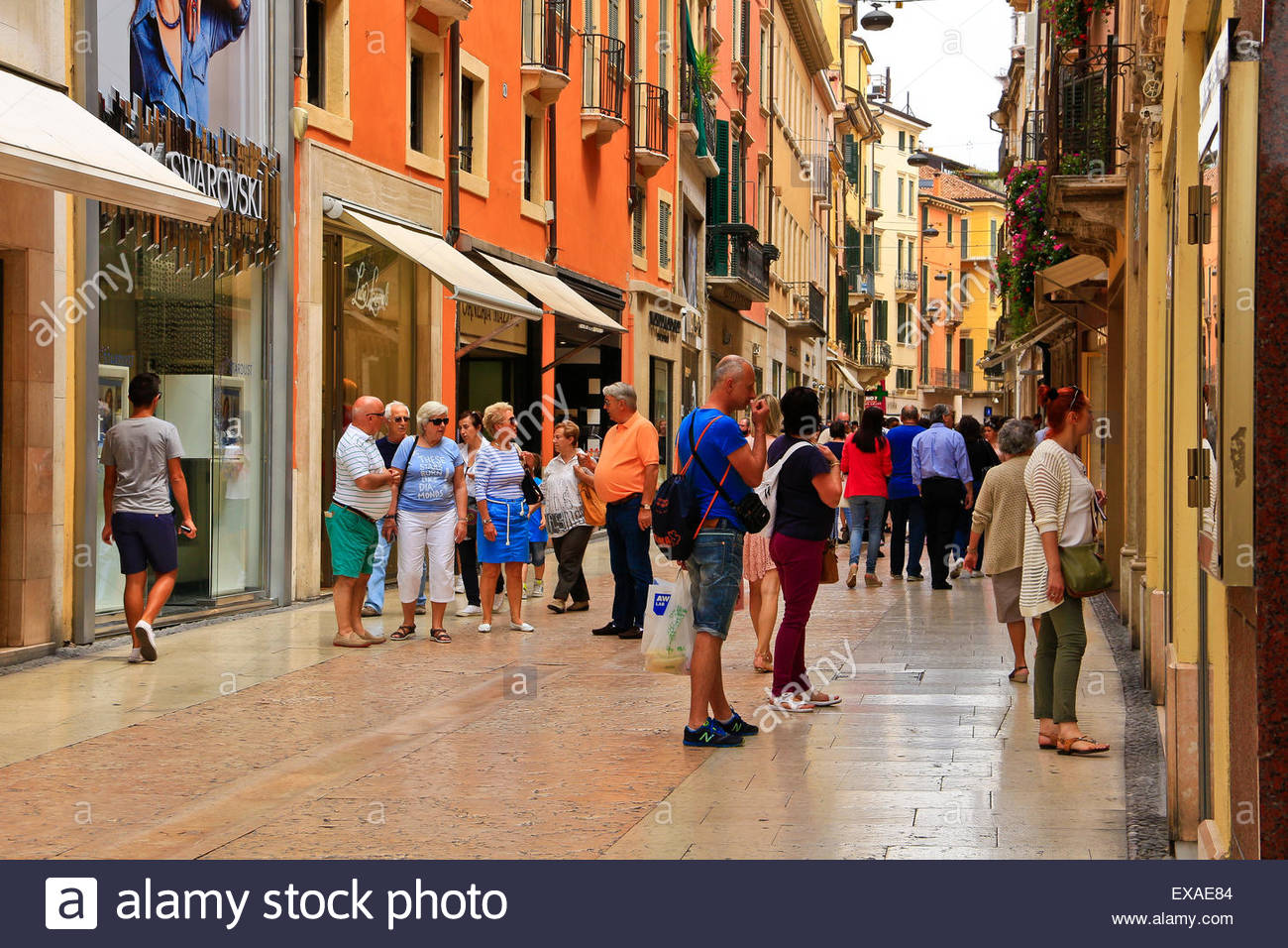 Tourists and shoppers in pretty city lane. Verona Italy Stock Photo