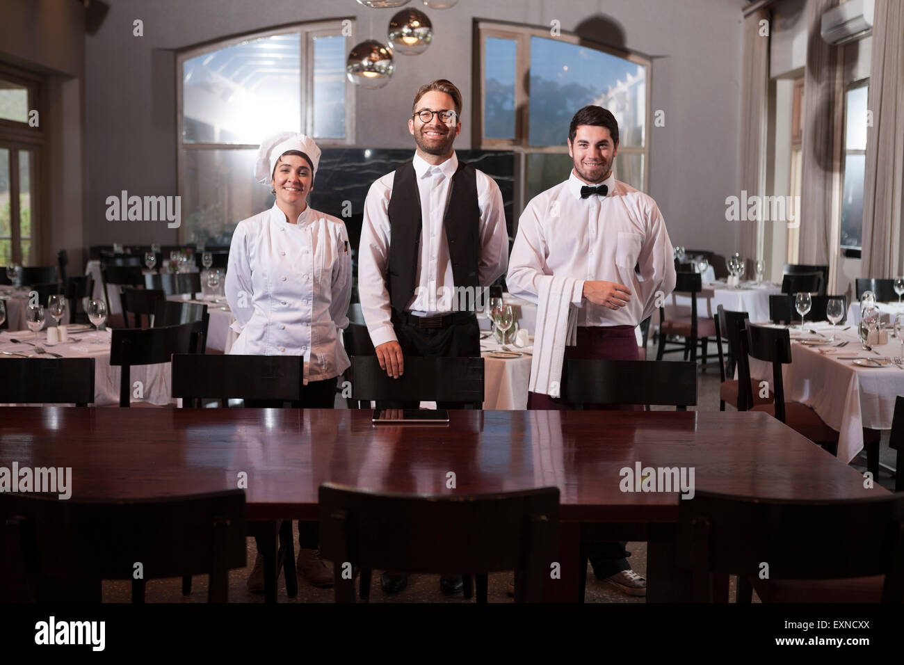 Restaurant employees receiving guests Stock Photo, Royalty Free Image