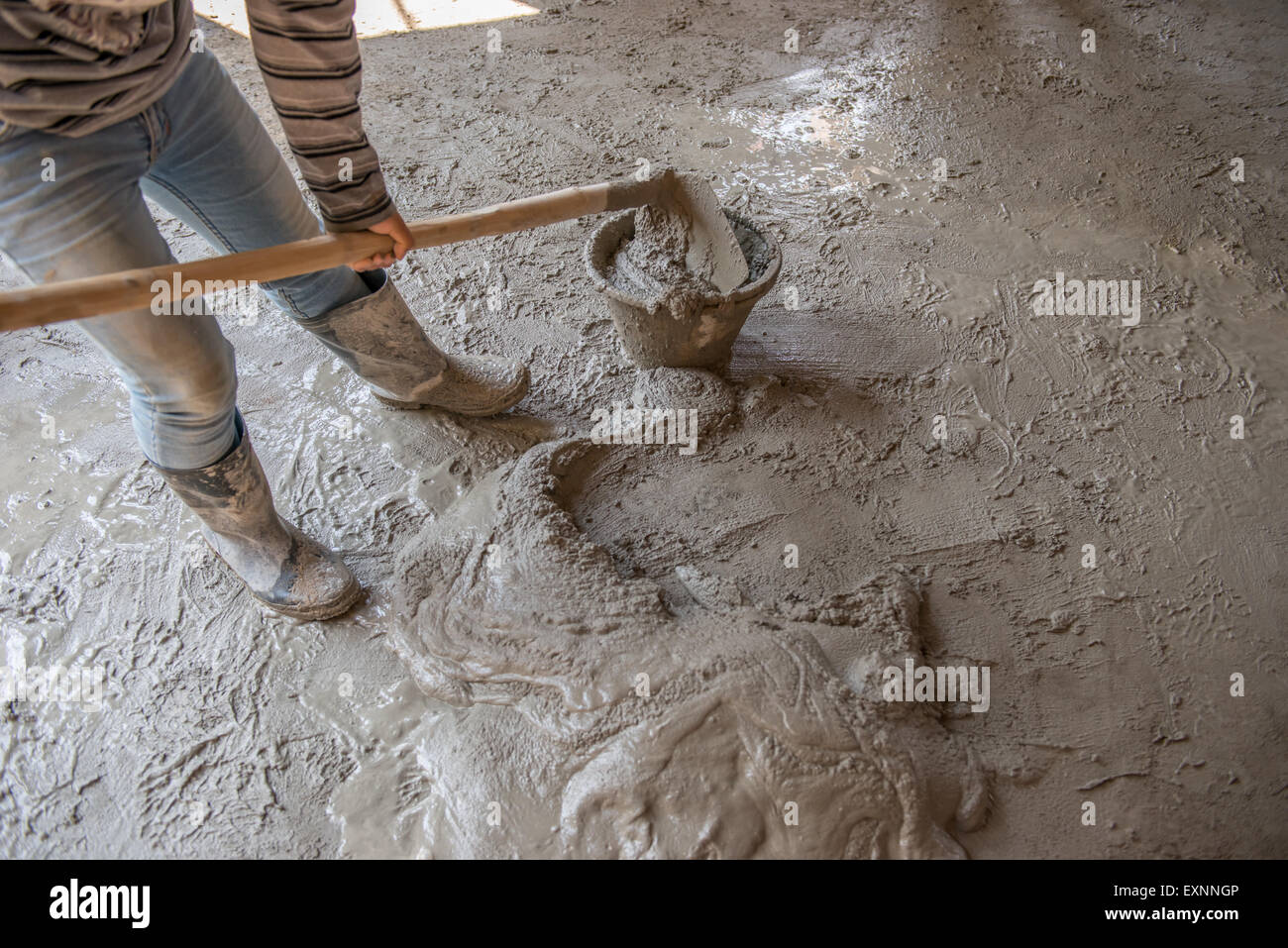 Worker is mixing mortar prepare for plastering Stock Photo, Royalty