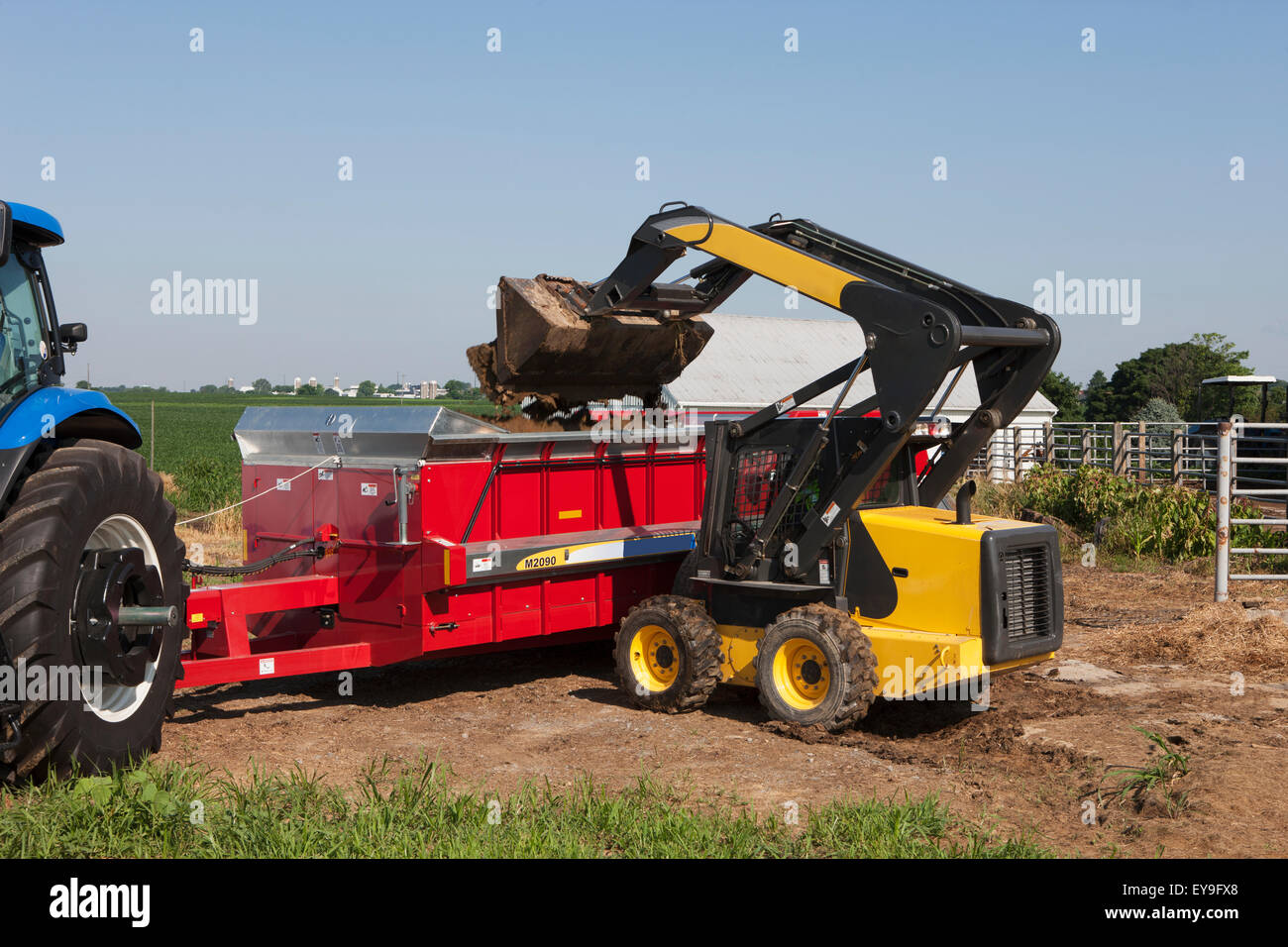 Loading,Manure,Skid Steer Loader,box spreader Stock Photo, Royalty Free