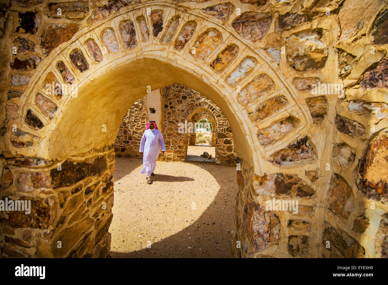 Moor walking beneath arch of old building; Taif, Saudi Arabia Stock