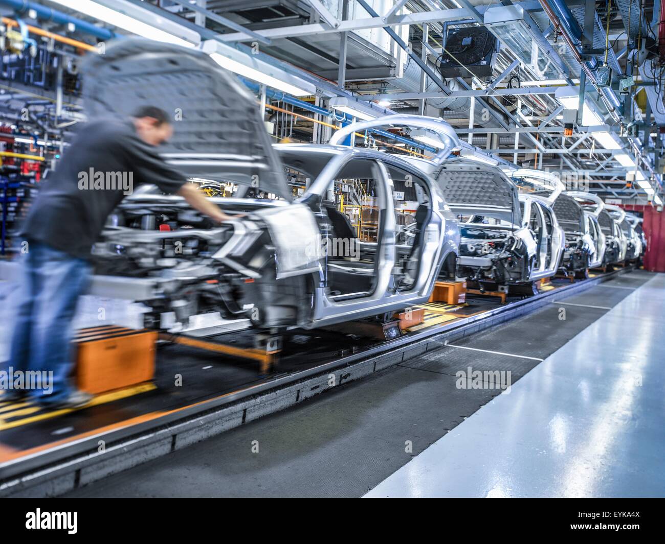 Worker on car production line in car factory Stock Photo, Royalty Free