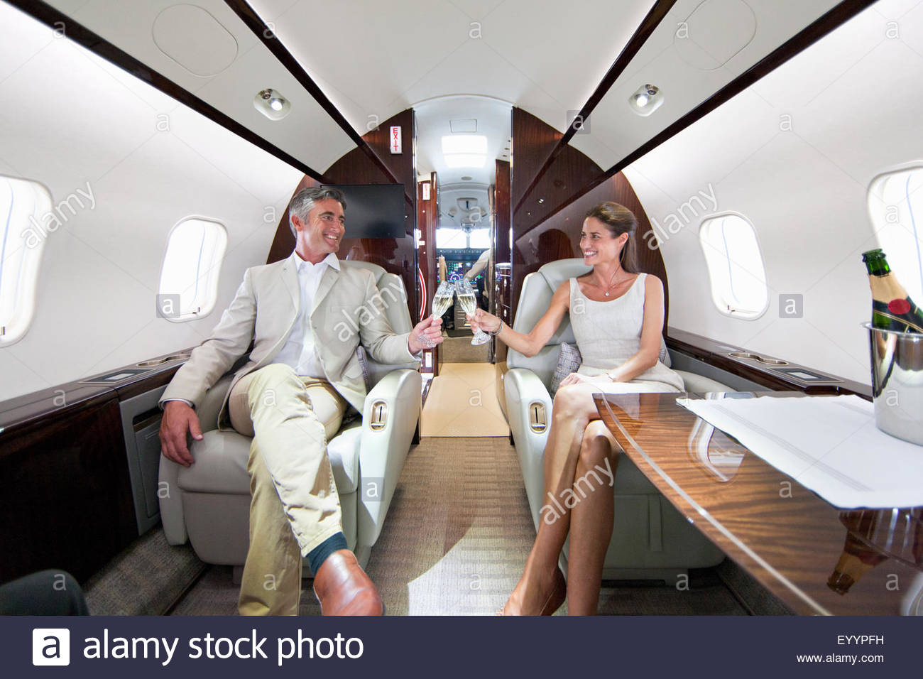 Private Jets For Rent >> Smiling couple making a toast with champagne in private ... Private Jets For Rent >> Smiling couple making a toast with champagne in private ...