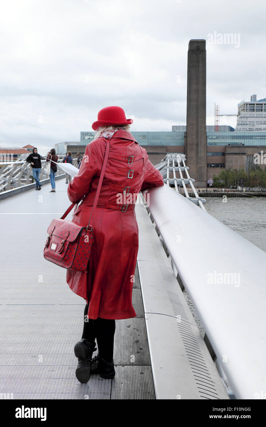 Rear View Of Tourist In Red Coat &amp Bowler Hat Standing On The