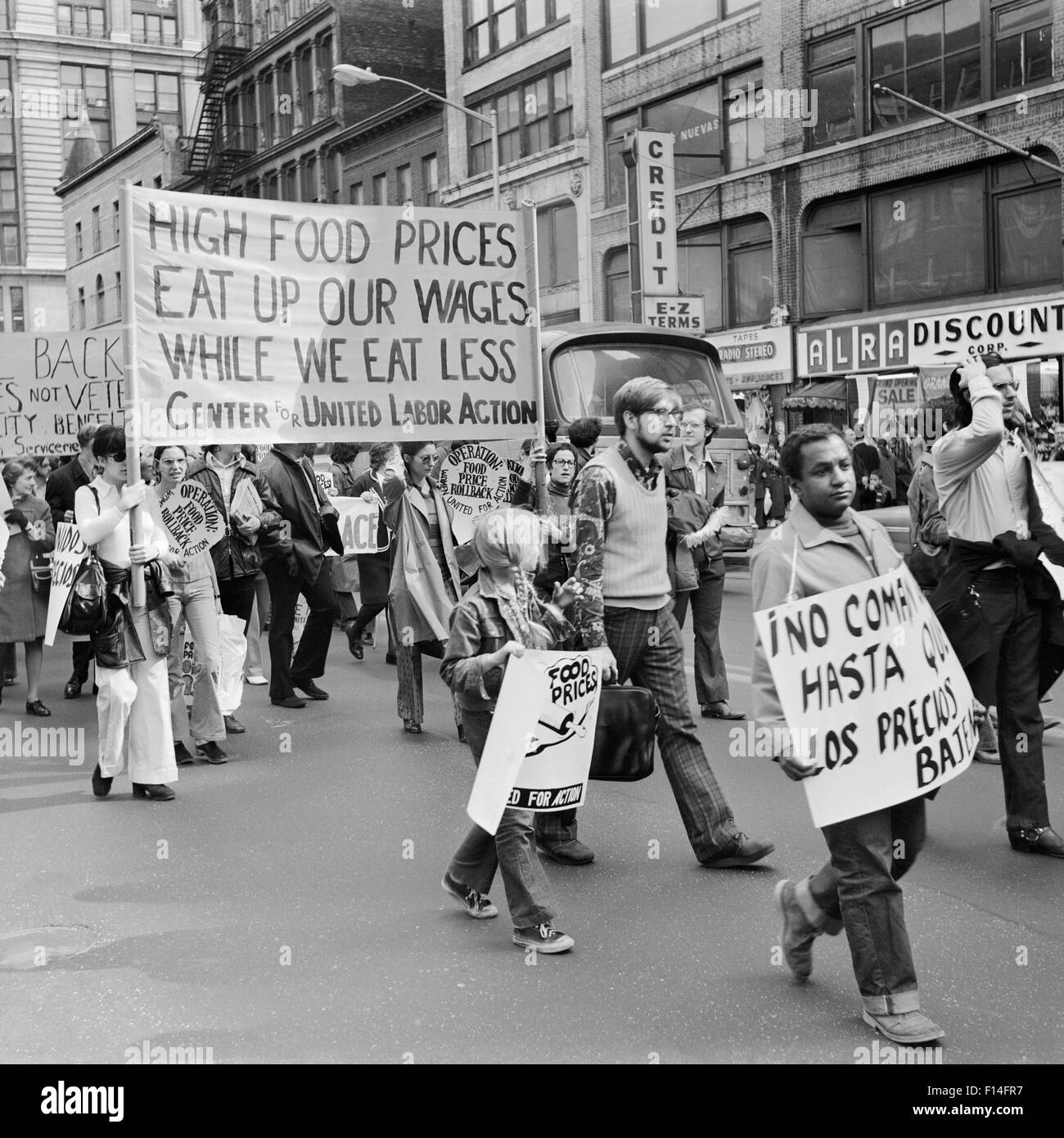 1970s PEOPLE IN DEMONSTRATION AGAINST HIGH FOOD PRICES CARRYING SIGNS