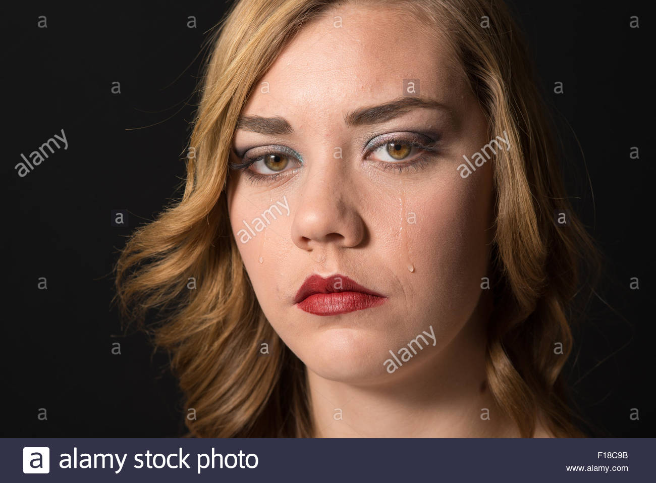 Teen Girl Crying Looking At The Camera With Tears On Hear Cheeks
