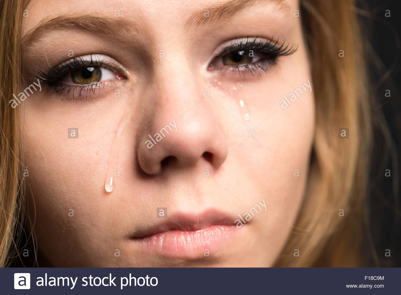Teen Girl Crying Looking At The Camera With Tears On Hear Cheeks Stock