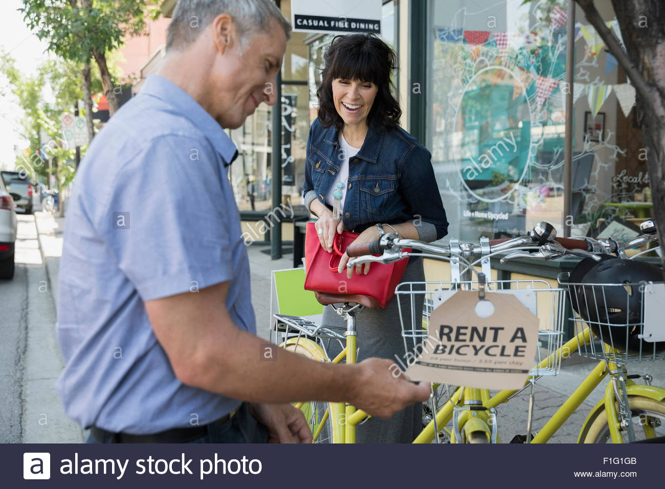 Couple Renting Bicycle On Sidewalk Stock Photo Alamy