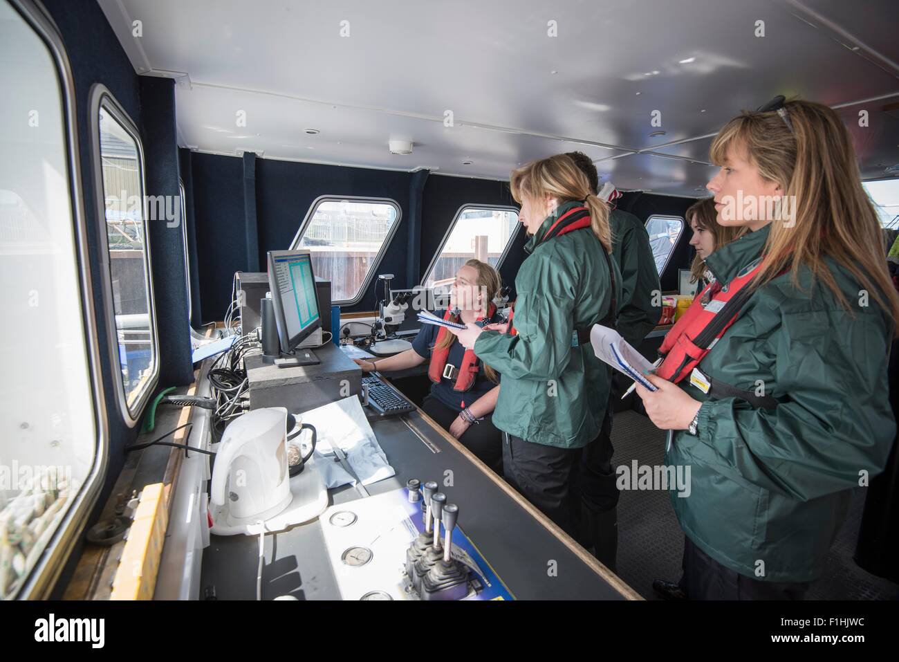 Marine biologists in laboratory on research ship Stock Photo, Royalty