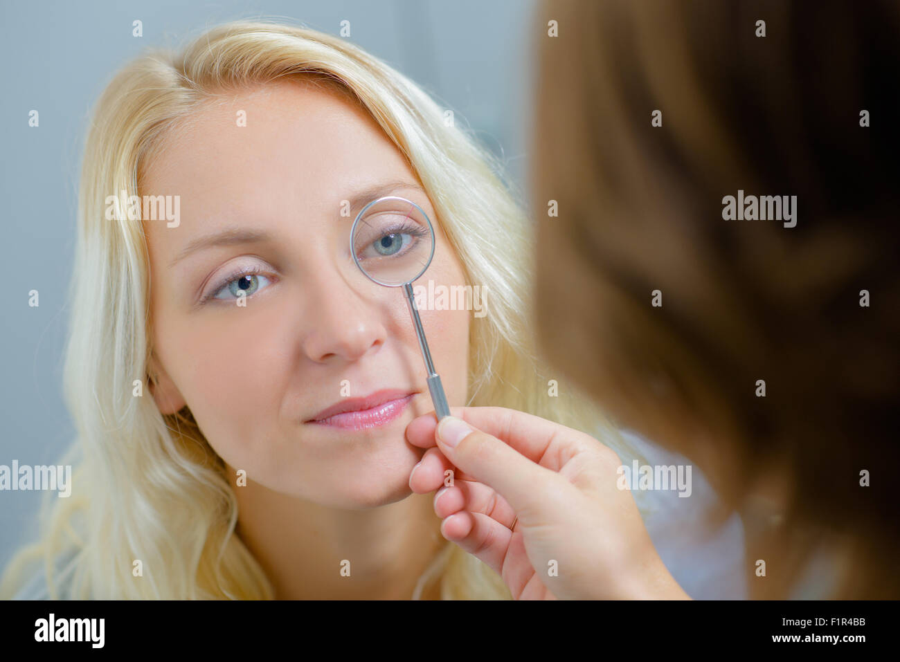 Optician Checking A Woman S Eye Stock Photo Alamy