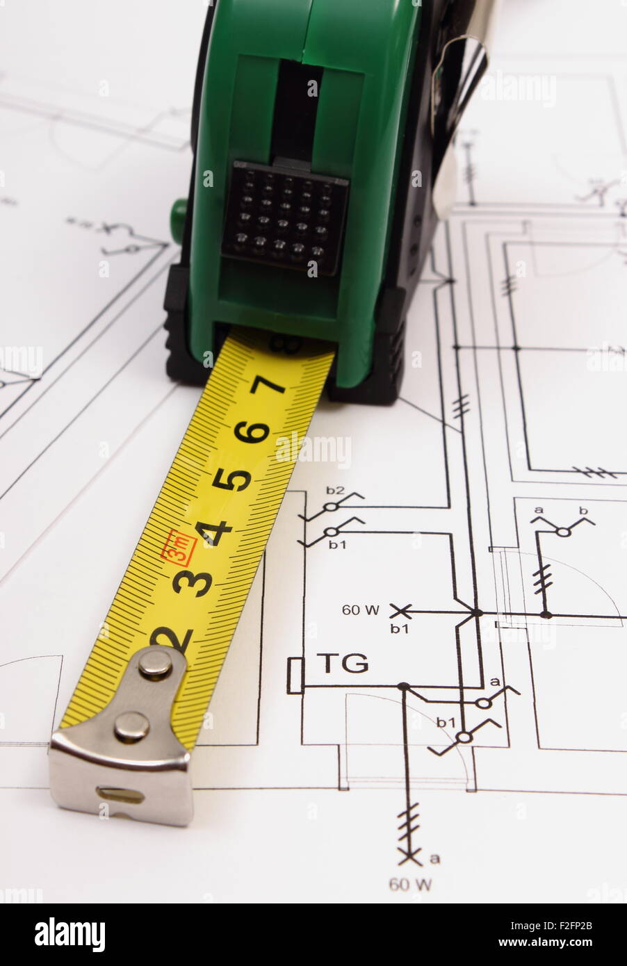 Tape measure on electrical construction drawing of house, work tool