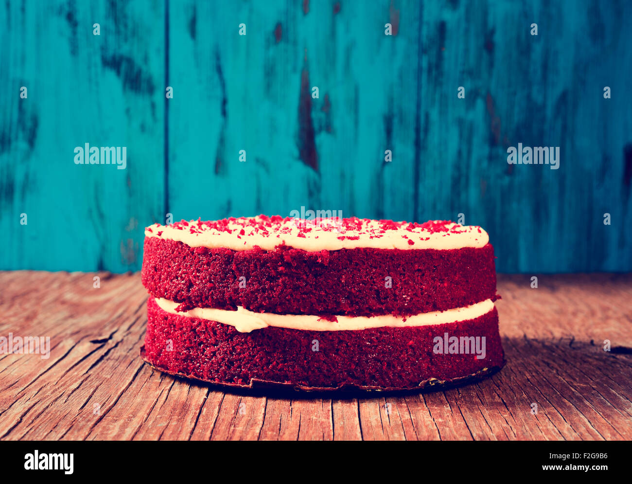 A Red Velvet Cake On Rustic Wooden Table And Blue Background With Filter Effect A Red Velvet Cake On Rustic Wooden Table And Blue Background With Filter Effect