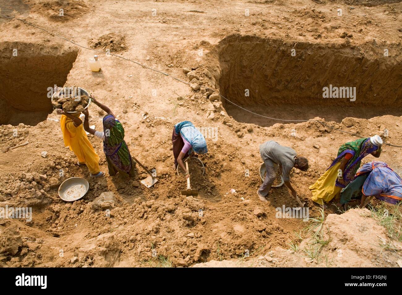 Workers at a construction site engaged in manual unskilled work Stock