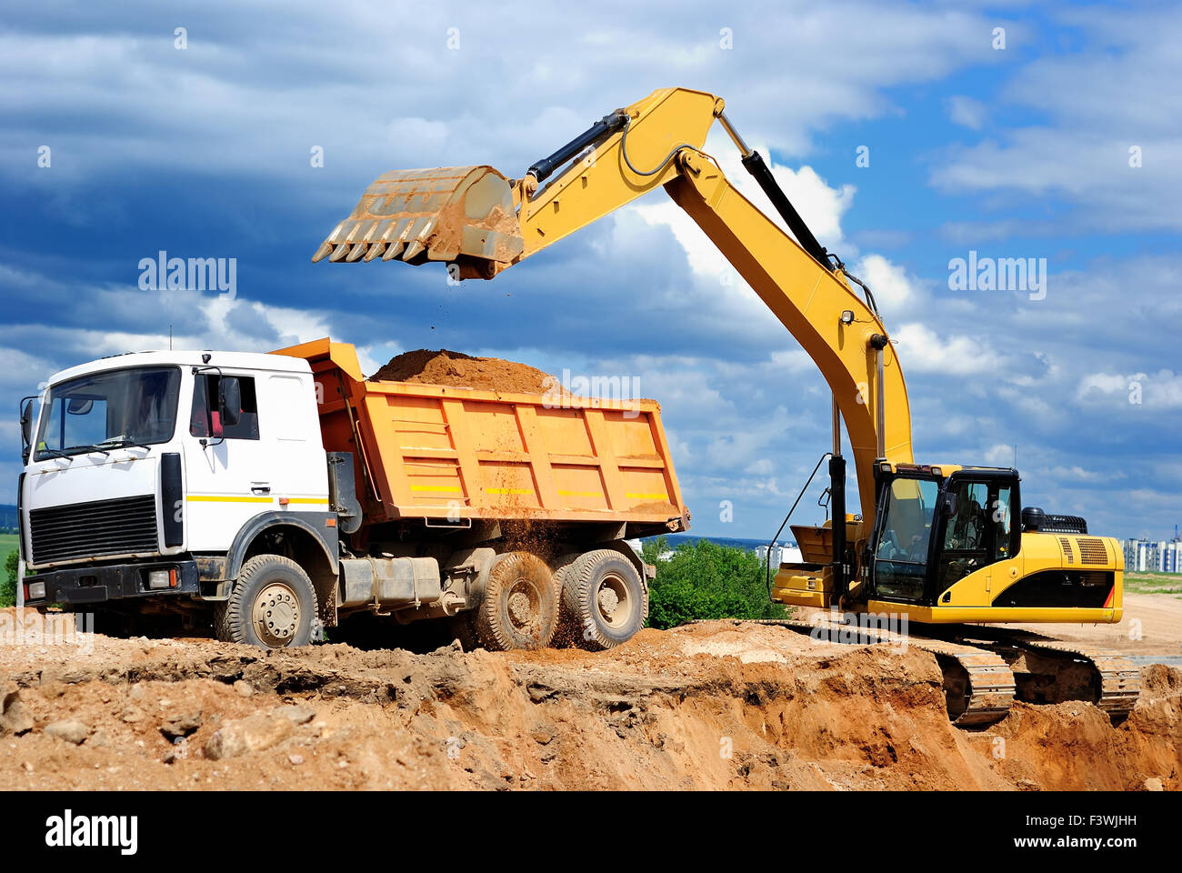 Excavator loading dumper truck Stock Photo 88459213 Alamy