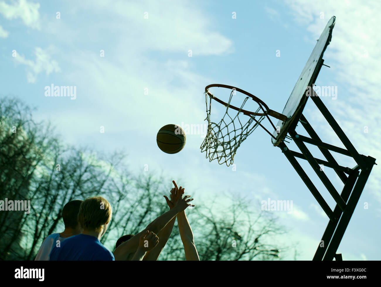People playing basketball outdoors Stock Photo, Royalty Free Image